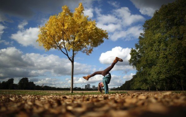 A-tourist-does-a-handstand-under-a-yellowing-tree-in-Hyde-Park-in-London-England-on-October-12-2012.-Peter-MacdiarmidGetty-Images-650x409